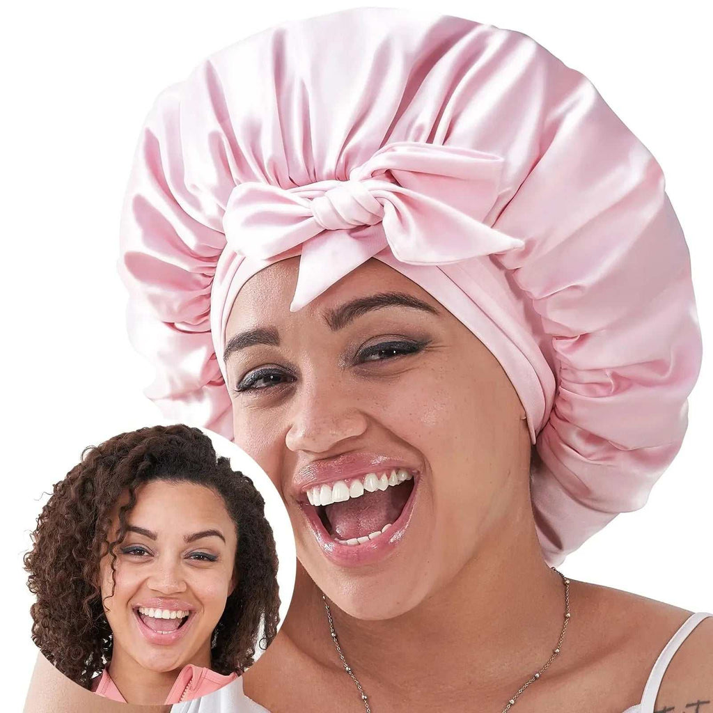 Woman wearing a pink silk sleep bonnet protecting curly natural hair overnight