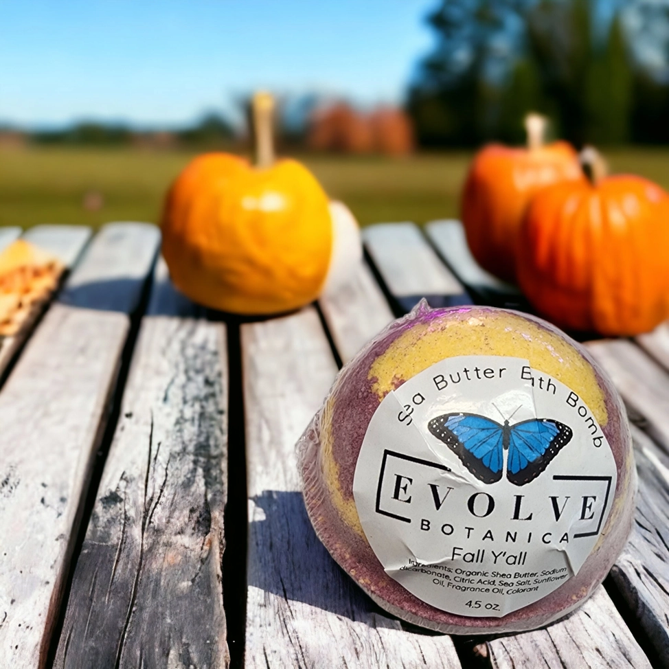 Pumpkin Spice Bath Bomb with shea butter on wooden table with pumpkins in autumn setting